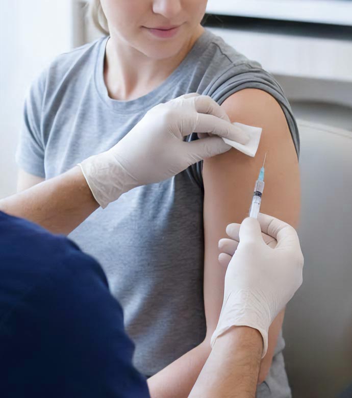 Impfung wird in den Oberarm einer Patientin verabreicht